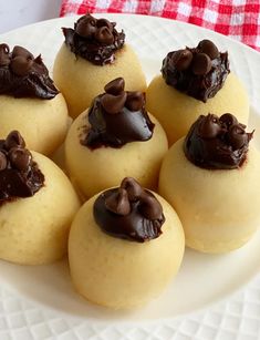 small desserts are arranged on a white plate