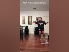 two men in black line dance on wooden floors