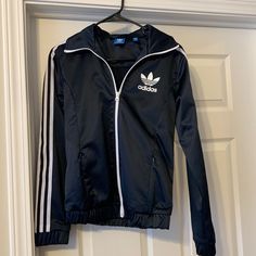 Nwot Adidas Shiny Navy, Has A Sheen That Feels So Nice White Stripes Down Sleeves Elasticized Waist Band Full Zip 2 Zipped Pockets In Front Size Small Adidas Long Sleeve Windbreaker For Fall, Adidas Navy Long Sleeve Track Jacket, Navy Adidas Long Sleeve Track Jacket, Navy Long Sleeve Track Jacket For Spring, Adidas Fitted Hooded Outerwear, Adidas Fitted Long Sleeve Outerwear, Casual Navy Track Jacket, Fitted Long Sleeve Adidas Outerwear, Navy Long Sleeve Windbreaker