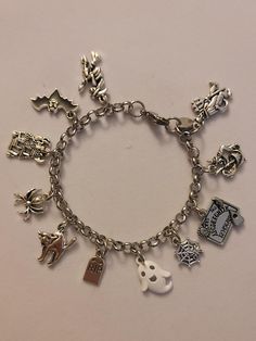 Silver Halloween Chain Bracelet is 7.5 inched long, however we can make it any size you need.  If you need a size different from the 7.5 inch please just note the size you need in the message to seller when placing your order and we will follow your directions.  Bracelet is stainless steel and charms are of various different metals.  Bracelet comes with every charm shown in the photos. If you look at picture number 2 in the photo section, all of the charms are noted. Please feel free to message us with any questions you may have.  Thank you so much! Halloween Charm Bracelet, Charmed Show, Halloween Bracelet, Halloween Charms, Bracelet Chain, Halloween Jewelry, Bracelet Charm, Number 2, Charm Bracelets