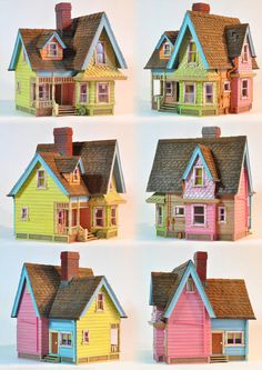 four different colored houses with brown roofs and windows on each house, all painted in different colors