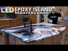 a man standing in front of a kitchen counter with an island made out of marble