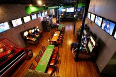 an overhead view of a sports bar with tables and televisions on the wall above