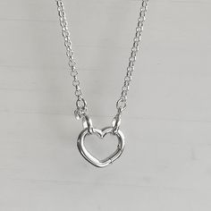 FREE USPS PRIORITY SHIPPING Reach for the timelessness of this sterling silver rolo chain necklace with a unique open heart front closing clasp. This necklace is made of sterling silver and is a perfect balance of modern charm and classic style Details: Chain: Solid Sterling Silver rolo chain, 2.4mm  Clasp: Solid sterling silver self-closing heart push clasp, sterling silver, 15mm heart. Length options: 15" to 28" Shipping:   Complimentary shipping in the USA Ready to ship within one business da Silver Open Heart Necklace With Adjustable Chain, Sterling Silver Heart Necklace With Lobster Clasp, Silver Sterling Silver Heart Necklace With Lobster Clasp, Sterling Silver Open Heart Necklace With Adjustable Chain, Silver Minimalist Open Heart Jewelry, Sterling Silver Open Heart Necklace With Lobster Clasp, Silver Heart-shaped Jewelry With Cable Chain, Silver Heart Necklace With Lobster Clasp For Everyday, Silver Heart Jewelry With Cable Chain