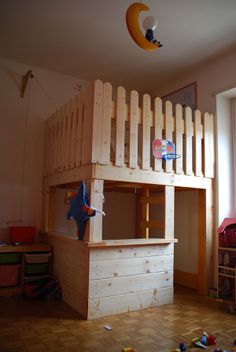 a loft bed made out of pallets in a child's bedroom