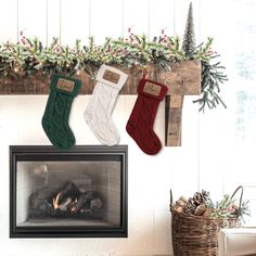 three stockings hanging from a mantel over a fireplace with christmas decorations on the mantle