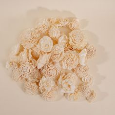 a pile of flowers sitting on top of a white table