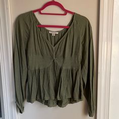 Nwot. Olive Green Babydoll Blouse With Twist Front And Detailing. Size S. Never Worn. Viscose/Modal Material Green V-neck Peasant Top For Fall, Flowy Cotton V-neck Tops, Fall Green V-neck Peasant Top, Green Flowy V-neck Top, Casual Flowy Long Sleeve Top, Flowy Long Sleeve Casual Top, Green Casual Peplum Top For Spring, Casual Green Peplum Top For Spring, Casual Green V-neck Peasant Top