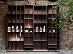 a clock is mounted on the wall next to shelves