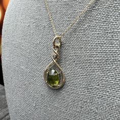 This hand-twisted pendant cradles a free form oval Peridot in a minimal prong setting. Chain Sold Separately Material: 14k Yellow Gold Stone Type: PeridotStone Size: 9mm x 7.5mm Diamond Quality: SI1GH Diamond Size: 2mm Diamond Weight: .03ct Chain: Sold separately; add to cart below. Shown with 1.0mm Solid Cable Chain. Dimensions: 29mm x 14mm Finish: high polish Weight: 2.5g Elegant Peridot Birthstone Gemstones, Yellow Gold Oval Wire Wrapped Necklace, Oval Peridot Jewelry For Formal Occasions, Formal Oval Peridot Jewelry, Yellow Gold Peridot Teardrop Jewelry, Gold Stone, Diamond Sizes, Cable Chain, Prong Setting