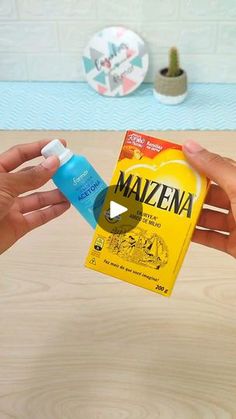 two hands holding an item with the word mauzena on it and one hand is holding a bottle