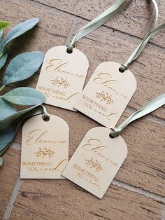 three tags with the words something you love written on them next to some green leaves