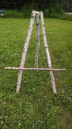 an old wooden ladder sitting in the grass