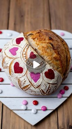 a loaf of bread sitting on top of a heart shaped plate with hearts around it