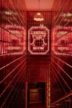 the inside of a room with red lights and bars on the walls that are lit up