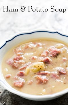 a white bowl filled with soup and meat on top of a doily covered table