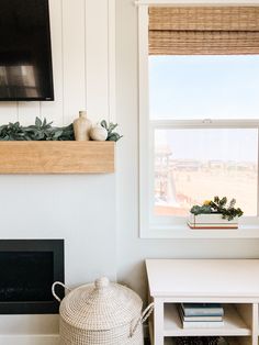 a living room with white walls and a large window