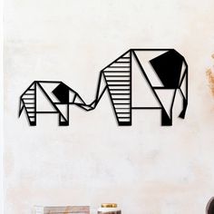 an elephant wall decal is shown on the wall next to a vase with flowers