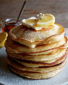 a stack of lemon ricotta pancakes with a speech bubble above it that reads, lemon ricotta pancakes