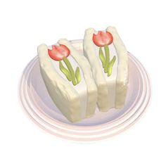 two pieces of cake with flowers on them sitting on a plate next to each other