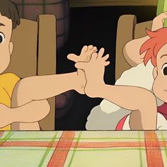 two cartoon characters sitting at a table with one holding the other's arm out