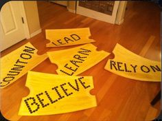 four yellow signs that say lead, believe, and don't leave on the floor