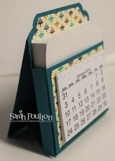 a desk calendar holder made out of an open book