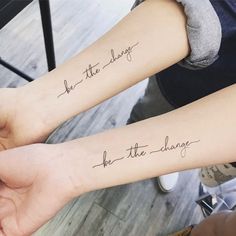 two people with matching tattoos on their arms that say, be the living and she's the change