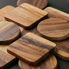 wooden coasters are arranged on top of each other in the shape of circles and rectangles