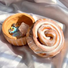 two glazed donuts with frosting inside on a white cloth