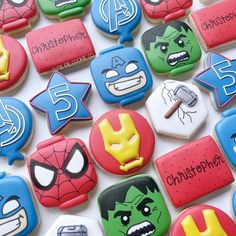 many decorated cookies are displayed on a white surface with the words, avengers and captain america