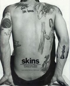 the back of a man with tattoos on his body