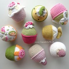 crocheted cupcakes and muffins are arranged together