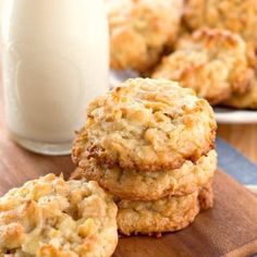 white chocolate macadamia coconut cookies on a cutting board next to a glass of milk