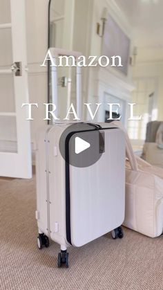 a white piece of luggage sitting on top of a carpeted floor