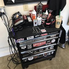 a bunch of tools are sitting on top of a black cart in front of a mirror