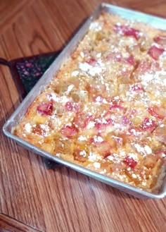 a square cake sitting on top of a wooden table