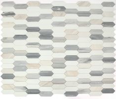 a white and grey mosaic tile wall with hexagonal tiles on the bottom half