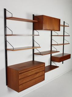 an empty room with shelves and drawers on the wall