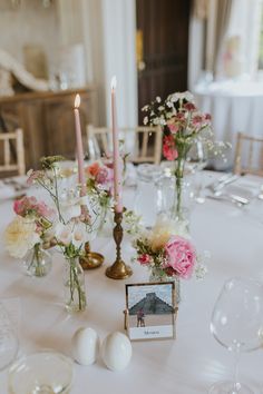 the table is set with flowers and candles