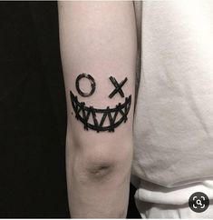 a black and white photo of a person with a tattoo on their arm that says xo