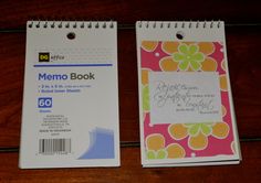 two memo books sitting on top of a wooden table