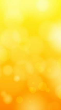 an orange and yellow blurry background with lots of small circles on the top right corner