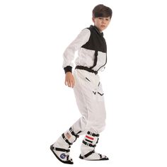 a young boy in white and black snowsuits standing with his feet on the ground