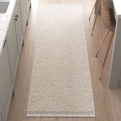 a white rug in the middle of a kitchen