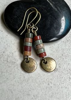 "red creek jasper earrings   small dangle boho earrings These earrings feature a small stack of Red Creek Jasper heishi stones. The earthy colors include green, golden yellow and rusty brown. Dangling below them is a small antiqued brass disc. Hook ear wires are antiqued brass. Length of earrings from top of ear wires is 1 1/2\". Jasper stones measure 4mm diameter. You can enter my shop here: gypsydangles.etsy.com" Bohemian Jasper Dangle Jewelry, Everyday Rustic Jewelry With Round Beads, Rustic Everyday Jewelry With Round Beads, Everyday Rustic Round Bead Jewelry, Earthy Red Handmade Jewelry, Nickel Free Jasper Bohemian Jewelry, Bohemian Jasper Jewelry Nickel Free, Nickel-free Bohemian Jasper Jewelry, Earthy Red Jewelry With Natural Stones