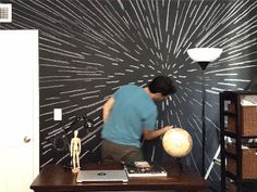 a man standing in front of a wooden desk