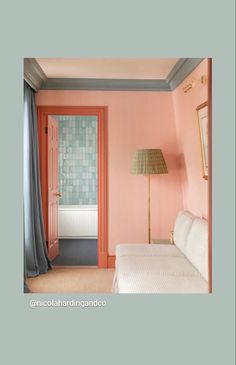 a bedroom with pink walls and blue curtains