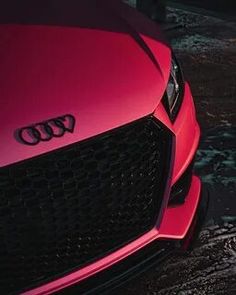 the front end of a red audi car