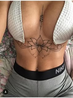 a woman with a tattoo on her stomach